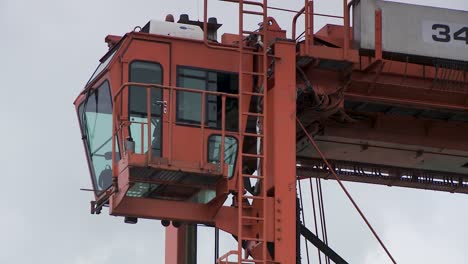 close-up of orange crane in rotterdam port, industrial setting