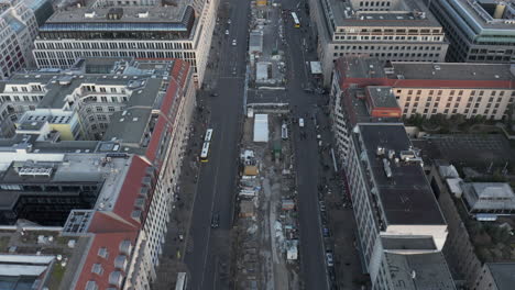 AERIAL:-Slowly-tilting-up-over-Berlin-Central-with-Pedestrians-on-Sidewalk-and-Car-Traffic