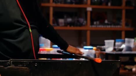 glassblower shaping a molten glass