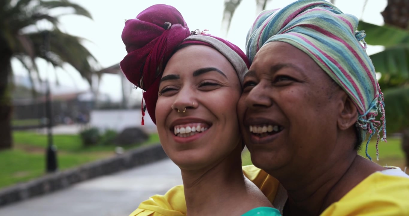 Happy African Women with Head Wraps Smiling in a Park