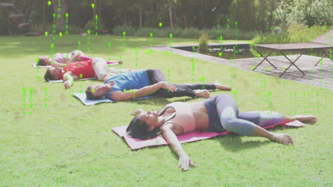 people relaxing on yoga mats outdoors with digital data animation overlay