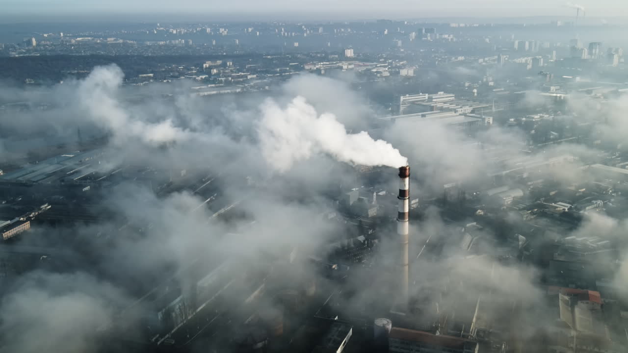 Aerial drone view of Chisinau. Thermal station with smoke coming out of the tube. Buildings, roads. Low clouds. Moldova