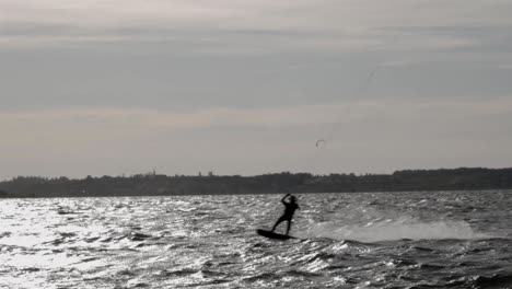 A-Kitesurfer-On-The-Baltic-Sea-In-Rewa,-Poland-On-A-Sunset---slowmo