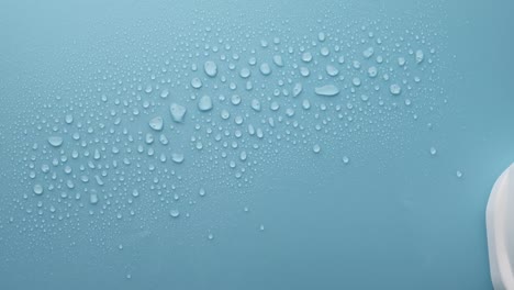 cleaning a surface with water drops