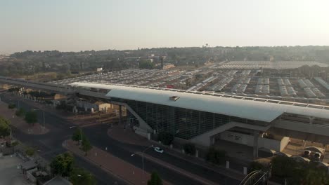 Drone-aerial-footage-of-a-Highspeed-commuter-train-station-with-huge-parking-lot