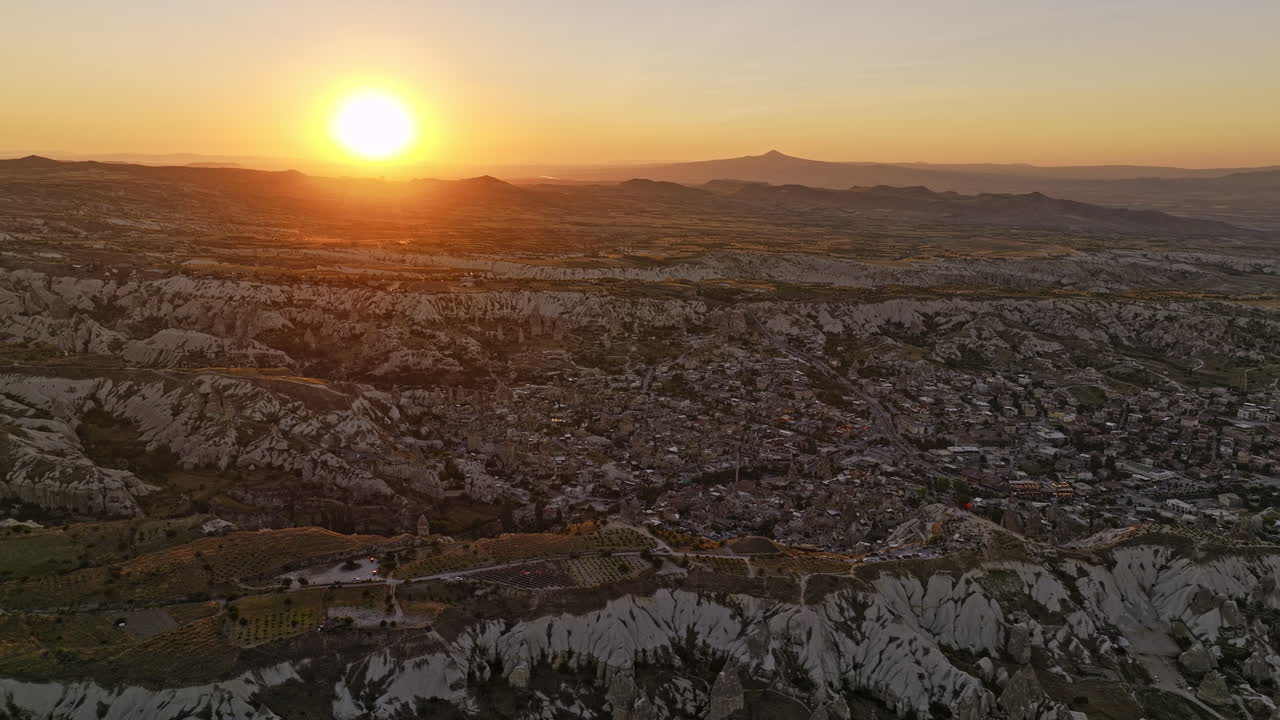 Göreme Turkey Aerial v3 panoramic panning view capturing big bright golden sun glowing in the sky and spectacular volcanic landforms with surreal rock formations - Shot with Mavic 3 Cine - July 2022