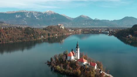 lake bled island in slovenia during the fall season with clear skies