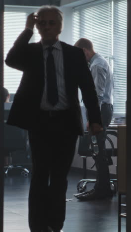 business person picking up papers from the floor