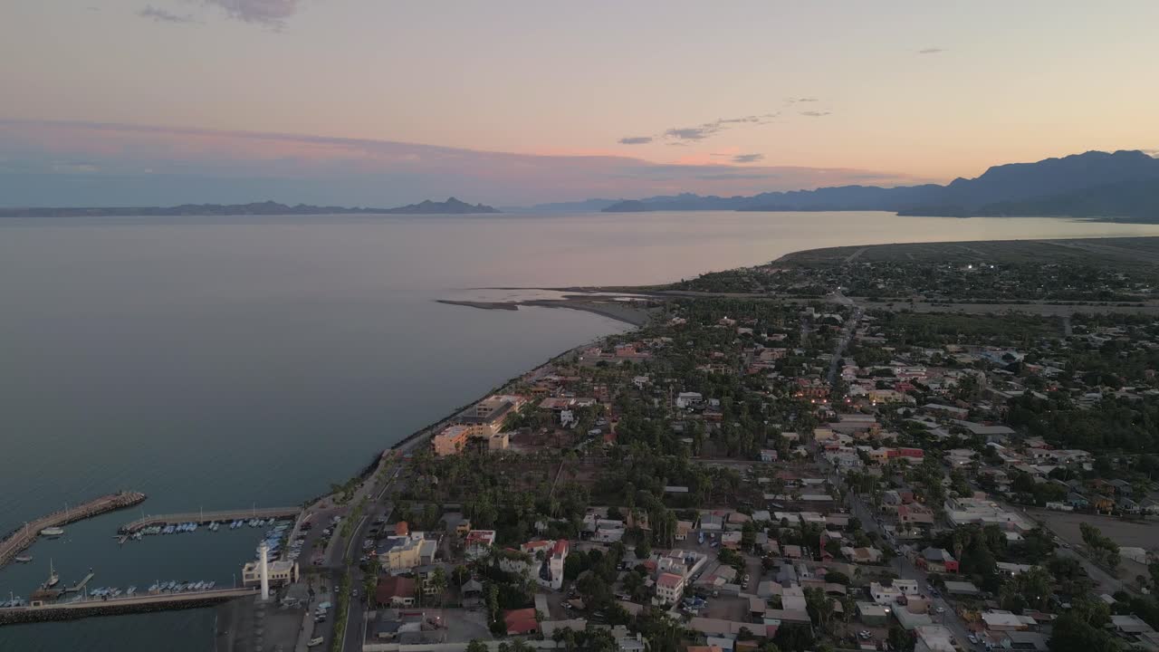 estableciendo una toma aérea de loreto, méxico, baja california, el horizonte del atardecer, la ciudad, el destino de viaje vibrante de américa latina, la hora dorada, las casas y las calles de la costa mexicana.