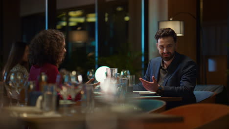 multiracial lovers chatting together in night restaurant. couple on dinner date.