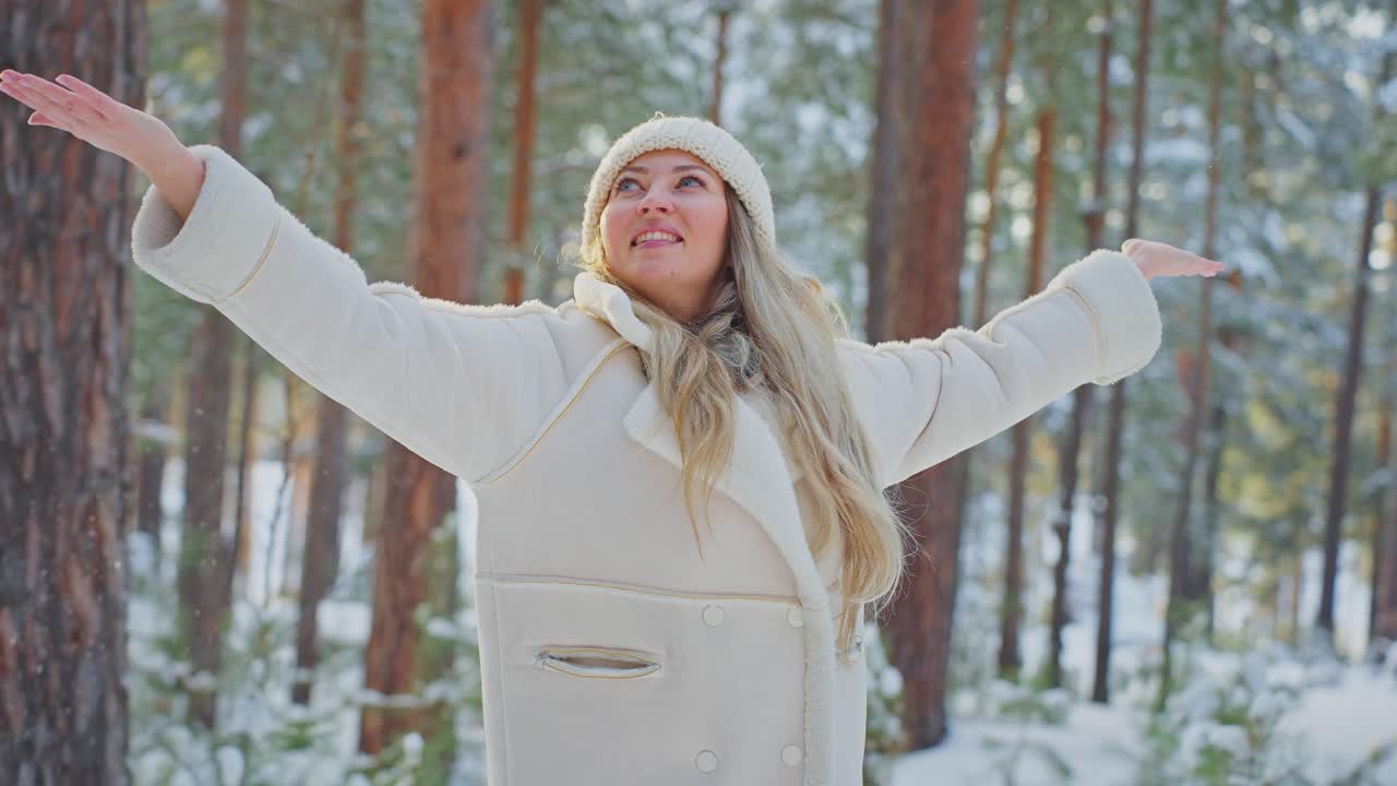 Woman enjoying a snowy winter day in the forest