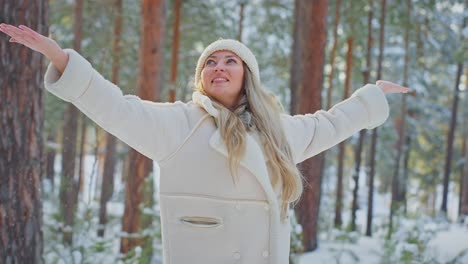 woman enjoying a snowy winter day in the forest