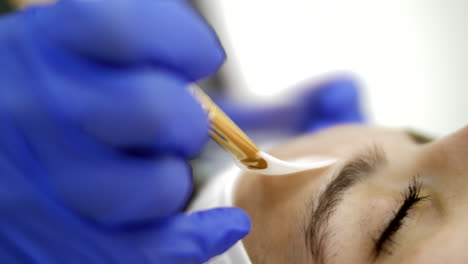 beautician doing an aesthetic treatment on a customer