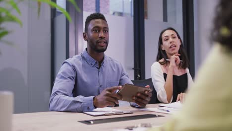 Diverse-group-of-business-people-working-together,-discussing-work-in-modern-office