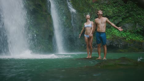 young couple exploring waterfalls