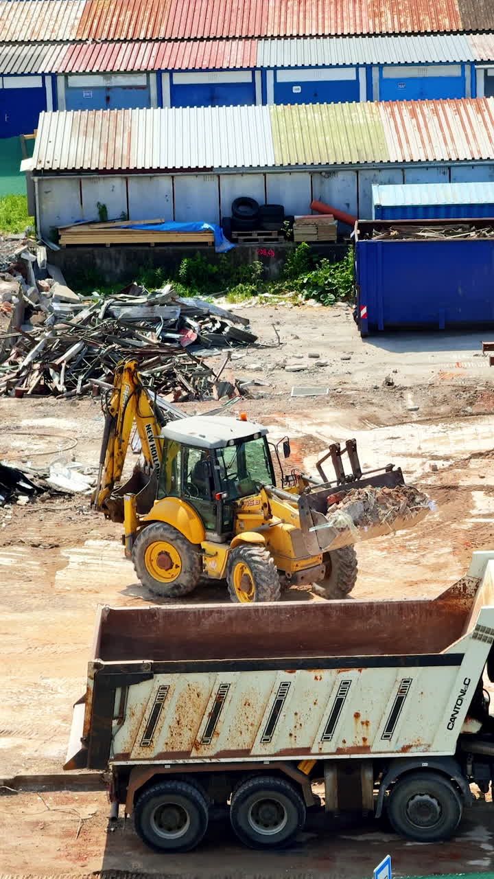 Active construction site. Excavator and dump truck operate at a construction site during the daytime, moving soil and materials efficiently