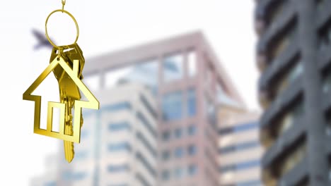 Animation-of-golden-house-keys-against-blurred-view-of-tall-buildings