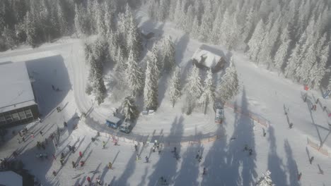 Drone-shot-of-a-Montrago-driving-in-the-snow-in-Pec-Pod-Snezkou,-Czech-Republic