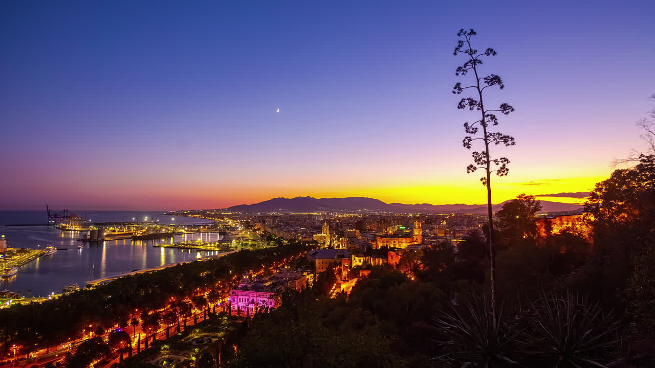 Crescent moon from sunset to nighttime over the Port of Malaga, Spain - time lapse