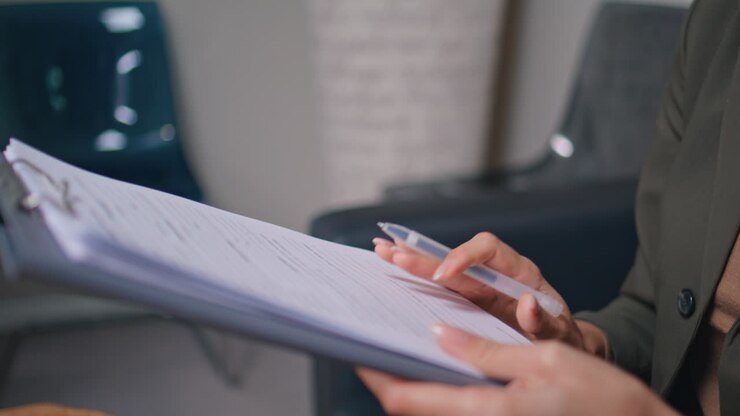 Woman hands holding insurance healthcare clinic closeup. Lady reading agreement