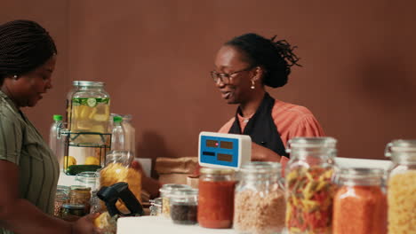 vendor using electronic scale at checkout counter