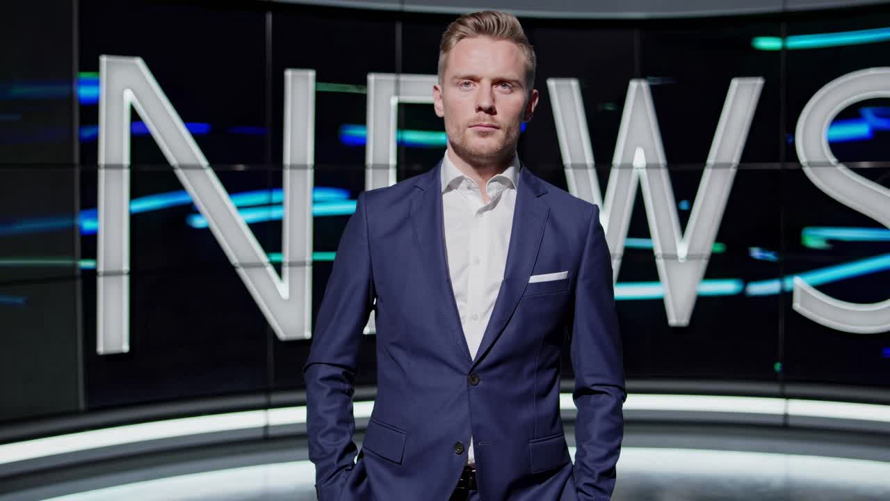 A news anchor in a blue suit stands confidently in a modern studio