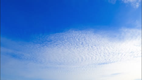 light soft white cloudscape spreading around the horizon. low angle view on the clouds floating in the sky.