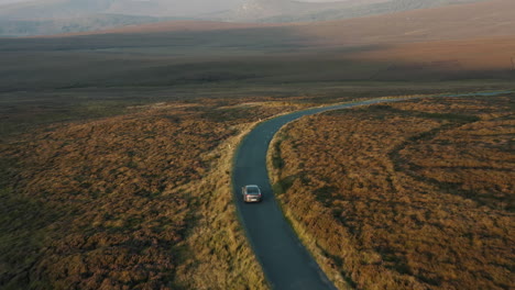 aerial view, car driving through mountain roads. 4k