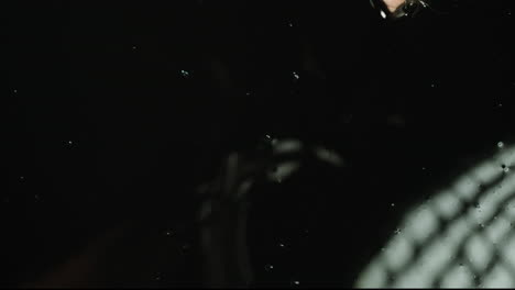 hand in black liquid