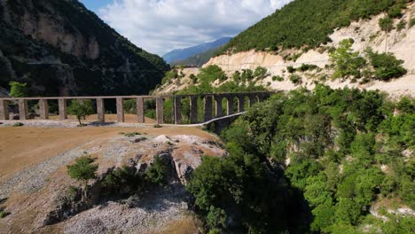 aqueduct of roman architecture standing on banks of vjosa river in albania, medieval construction