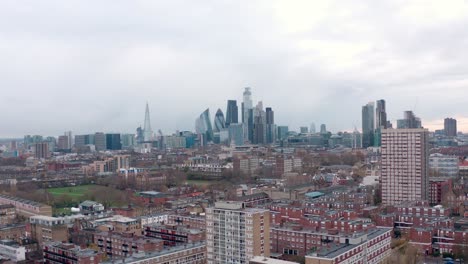 aerial circling slider shot over residential area to central london skyscrapers