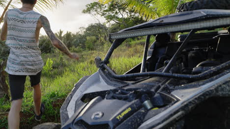 Dolly-Shot-Of-Male-Walking-Past-Parked-Dirt-Buggy-To-View-Sunset-At-Punta-Cana