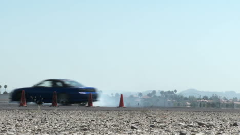 a car performs a drifting maneuver on a test track