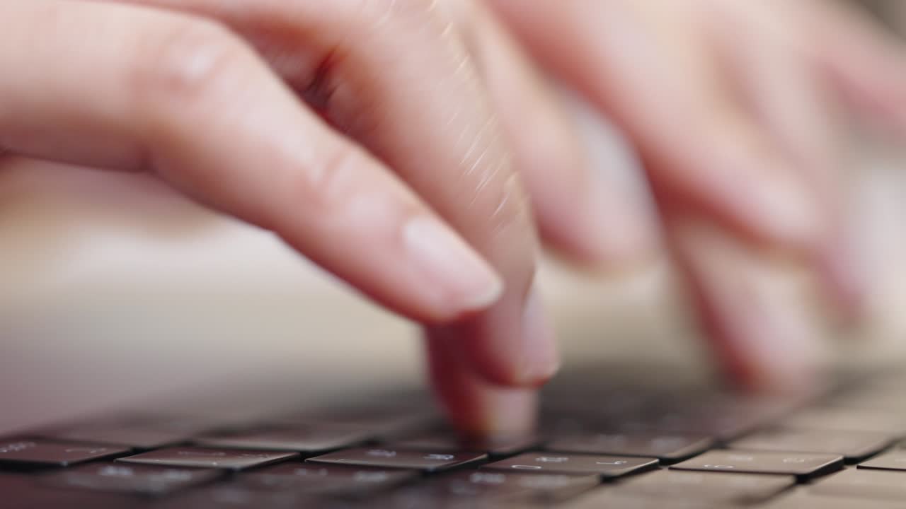 close up hand of a business woman typing keyboard laptop computer on desk office