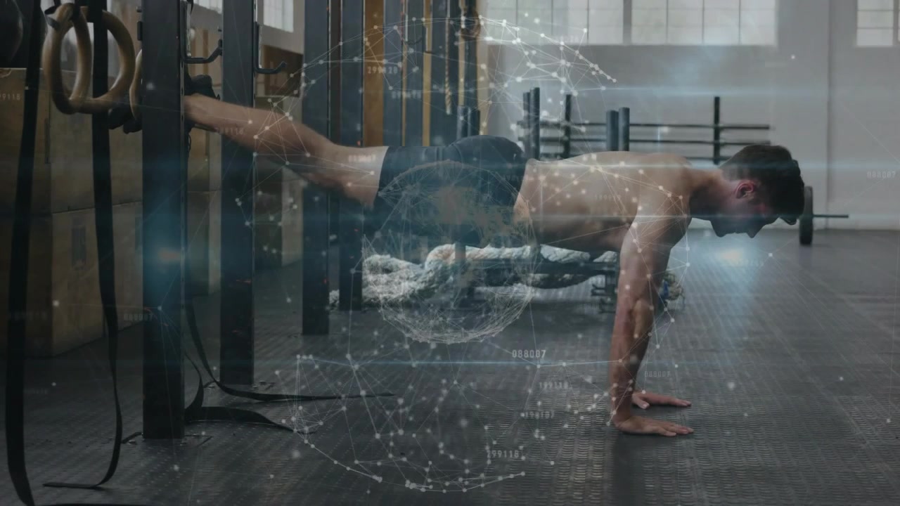 Man hooking feet into straps and doing decline push-ups for fitness, particles highlighting core