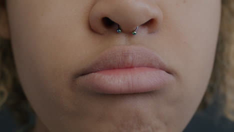close-up of a woman's face with nose piercing