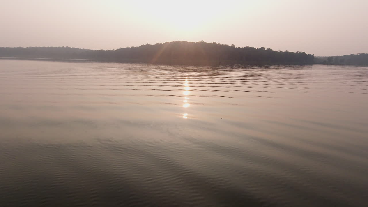 Evening boat safari on the tranquil Kabini River at dusk, serene and peaceful