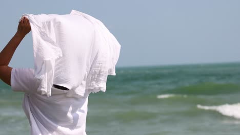 person enjoying the wind with a shirt at the beach