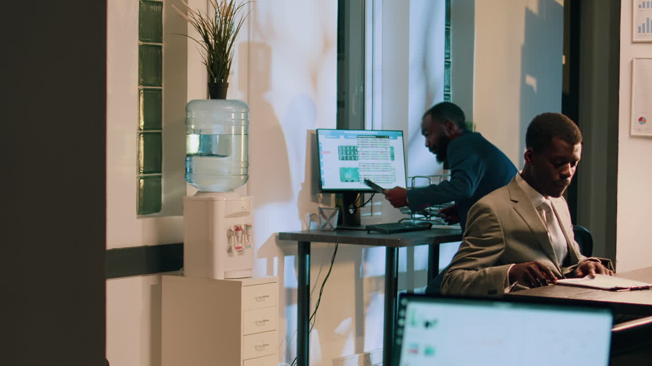 Office Workspace with Computers and Employees
