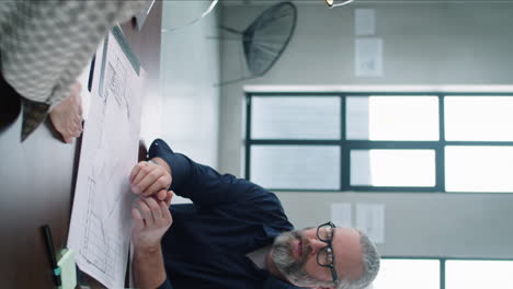 male architect shaking hands and speaking with female coworker