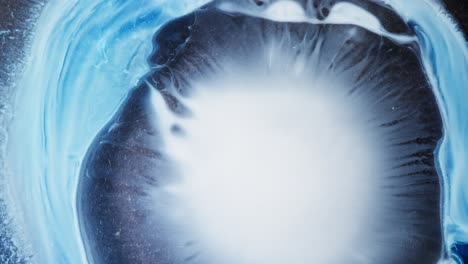 abstract blue and white ink bloom, macro shot of alcohol ink spreading in water