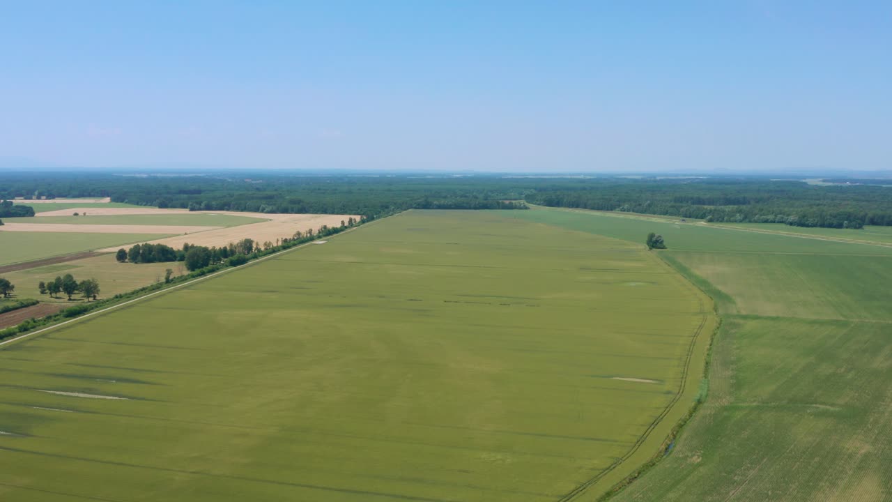 Aerial flyover of a pastoral landscape on a clear bright day near Lendava, Slovenia
