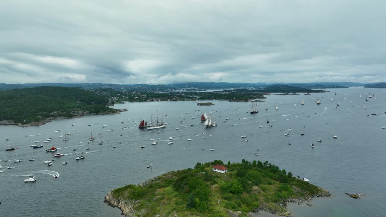 Boats gather at a maritime festival in a serene coastal area