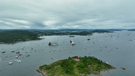 boats gather at a maritime festival in a serene coastal area