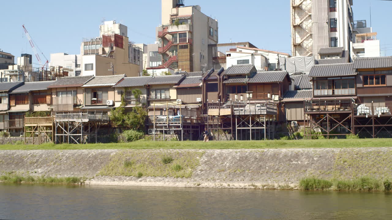 Houses crowding alongside a river in Kyoto, Japan