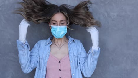 a cleared female nurse or woman with mask puts on a mask during the covid19 coronavirus pandemic epidemic