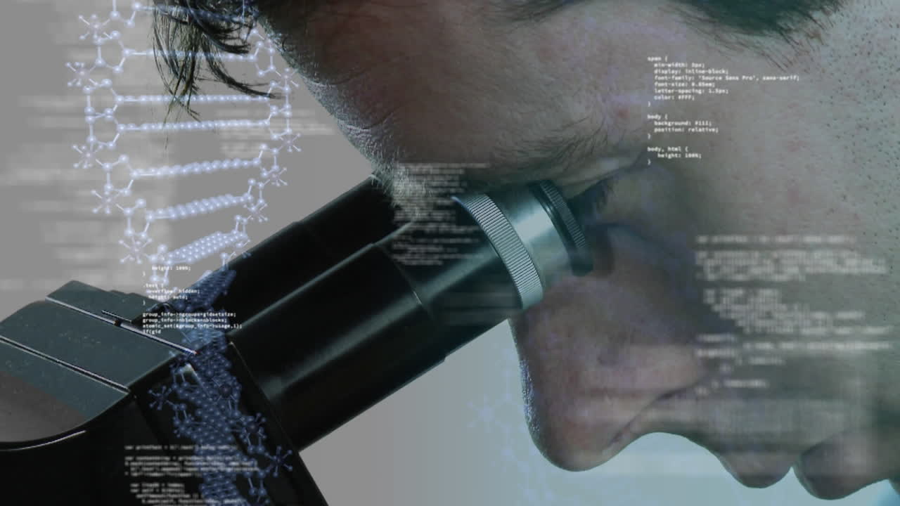 Scientist peeking in to a microscope