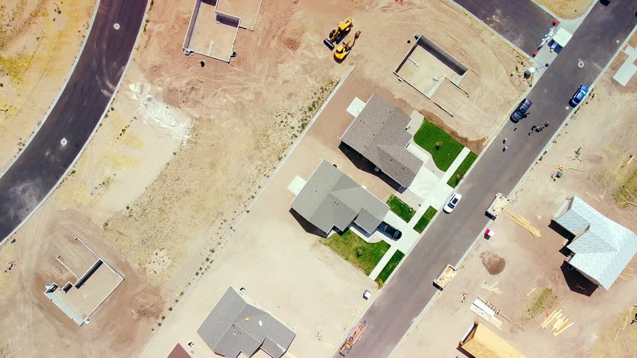 Looking down on roofs of new houses in middle of construction of Subdivision