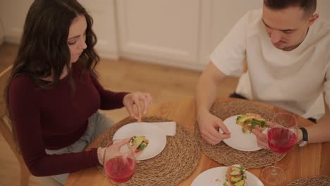 loving couple making a sandwich in kitchen-living room