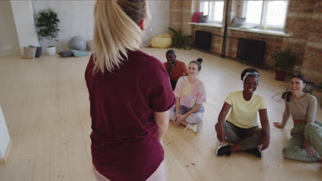 female dance teacher talking to diverse students